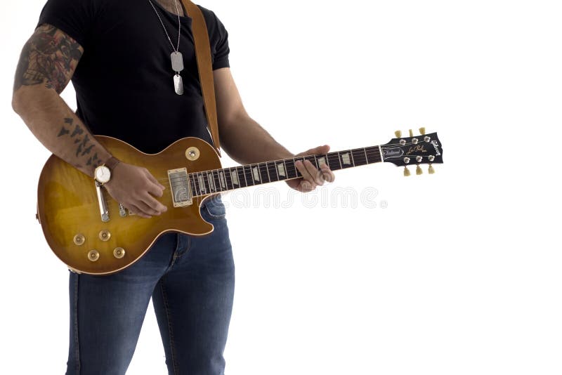 A man with an electric guitar Leaning against a cement wall Happy and relaxed Waiting for the show. royalty free stock photography A man with an electric guitar Leaning against a cement wall Happy and relaxed Waiting for the show. royalty free stock photography
