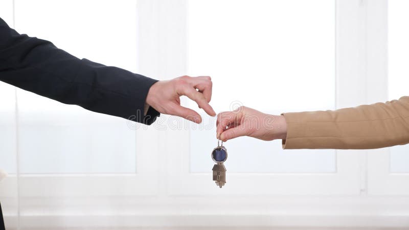 Man en vrouw schudden hand en hand over hand geven aan appartement