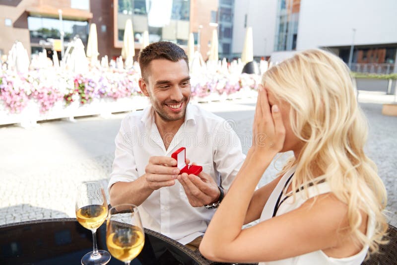 Man with engagement ring making proposal to woman