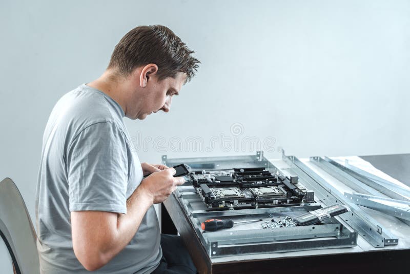 Man engineer,collector. Independent self computer assembly. Mounting in sockets processor,random access memory RAM royalty free stock photography