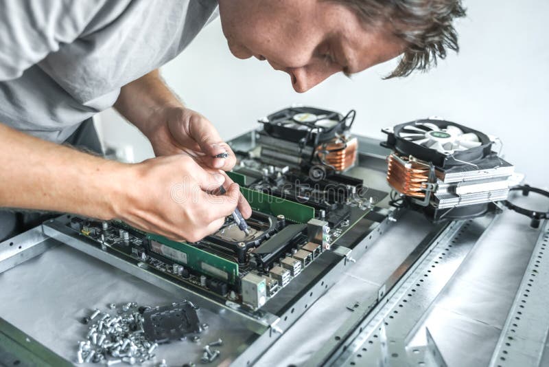 Man engineer,collector. Independent self computer assembly. Mounting in sockets processor,random access memory RAM royalty free stock images
