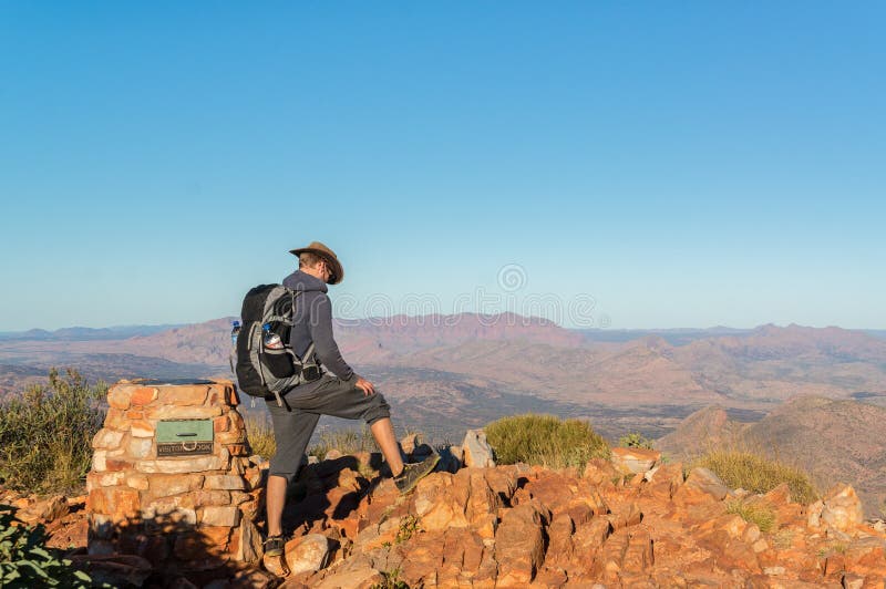 Man enjoying view after a hike to the top of Mount Sonder just outside Alice Springs, West MacDonnel National Park royalty free stock images Man enjoying view after a hike to the top of Mount Sonder just outside Alice Springs, West MacDonnel National Park royalty free stock images