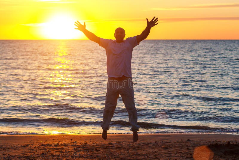A Man Enjoys Life On The Beach At Sunset Stock Photo Image Of Ocean