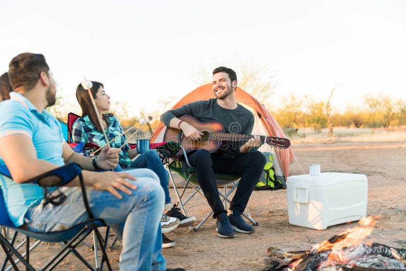 Man Entertaining Friends while Camping Stock Image - Image of ...