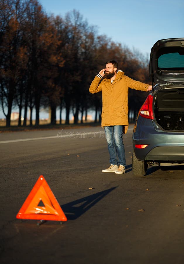 Man Examining Damaged Automobile Cars after Breaking Stock Image