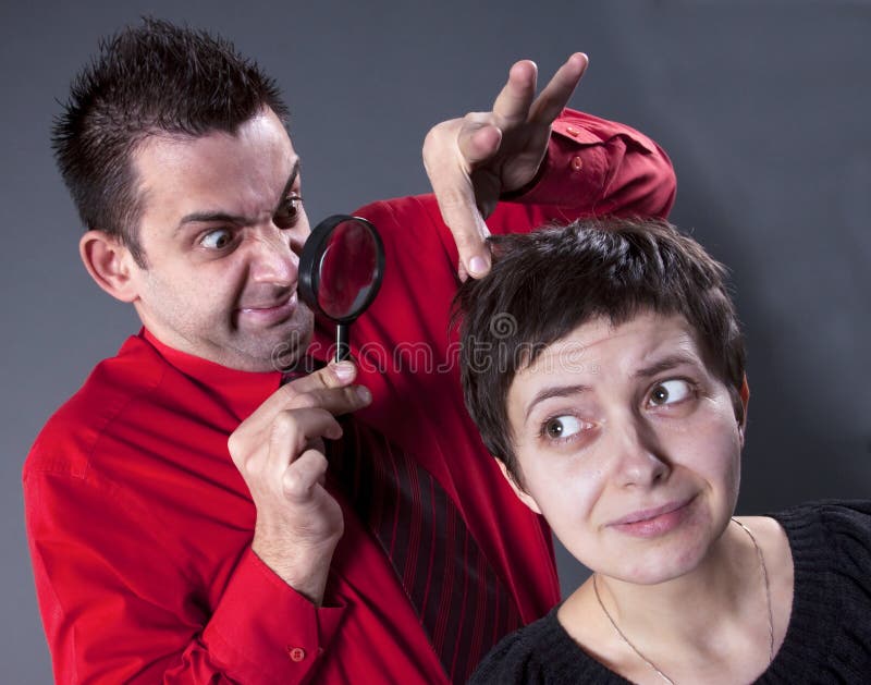 Man examining woman s hair