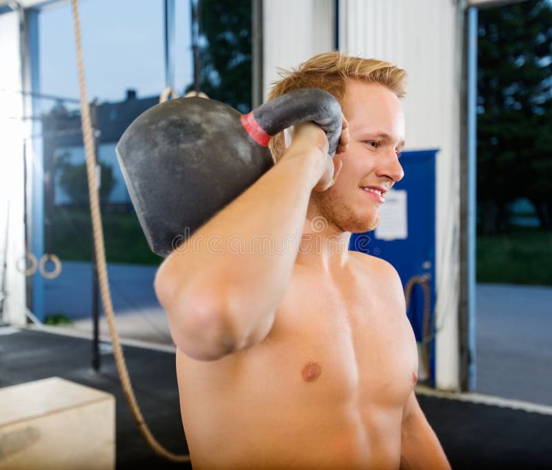 Man Exercising With Kettlebell In Gym royalty free stock image Man Exercising With Kettlebell In Gym royalty free stock image