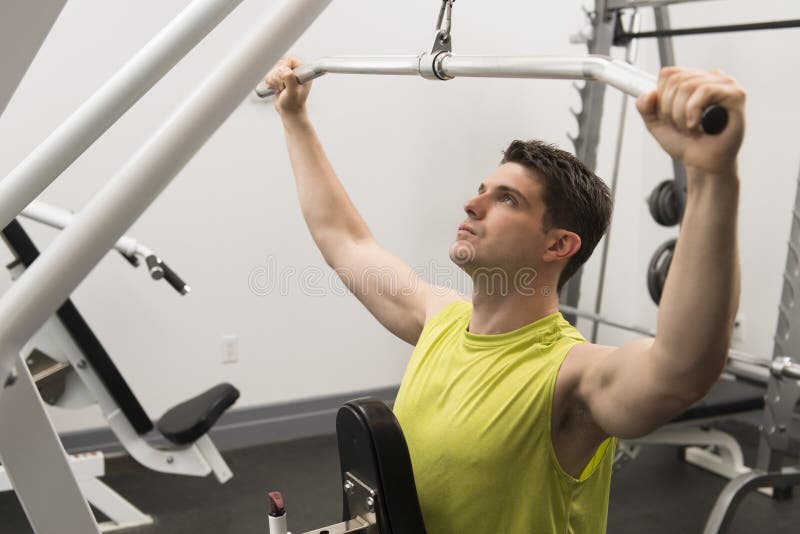 Man Exercising With Pulley In Gym Stock Image Image of handsome