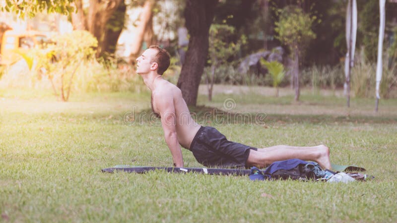 Man exercising by yoga in a outdoor park