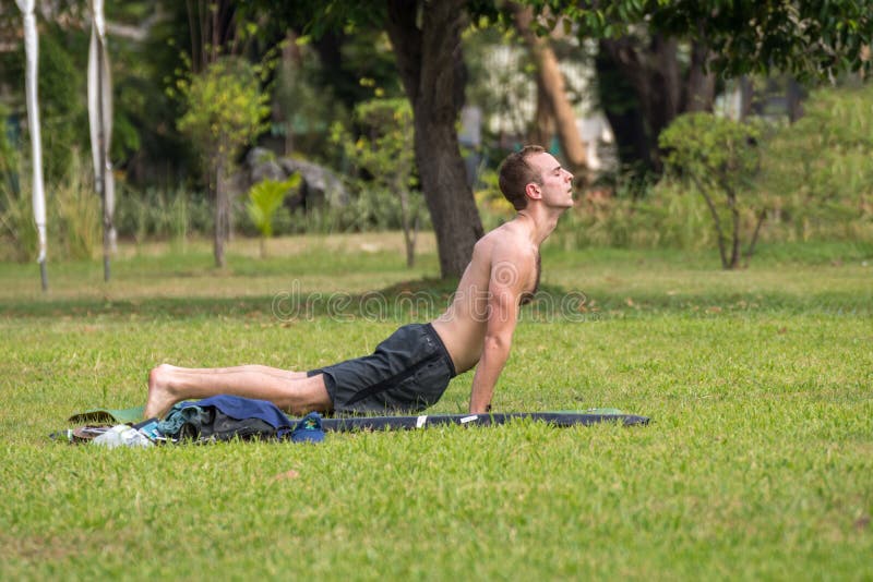 Man exercising by yoga in a outdoor park