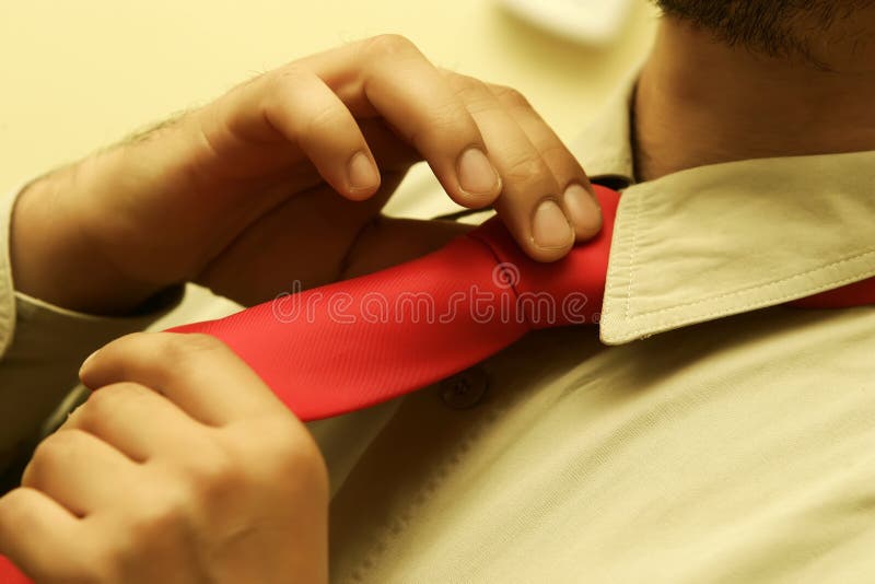 Man fastening tie