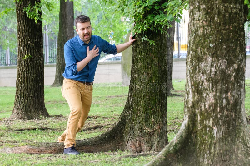 Man feels heartache suffering from cardio ailments and clutching