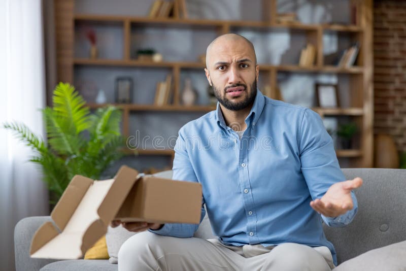 Frustrated man receiving empty package from online shopping royalty free stock photos