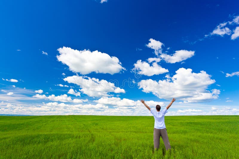 Man on field rising up hands