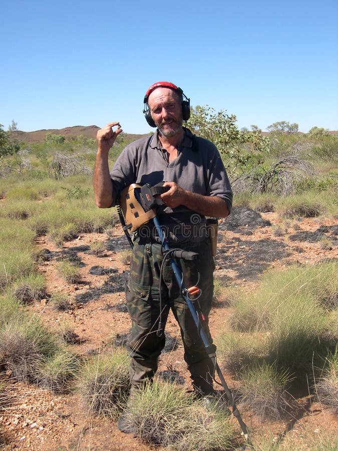 Man finding a gold nugget royalty free stock image