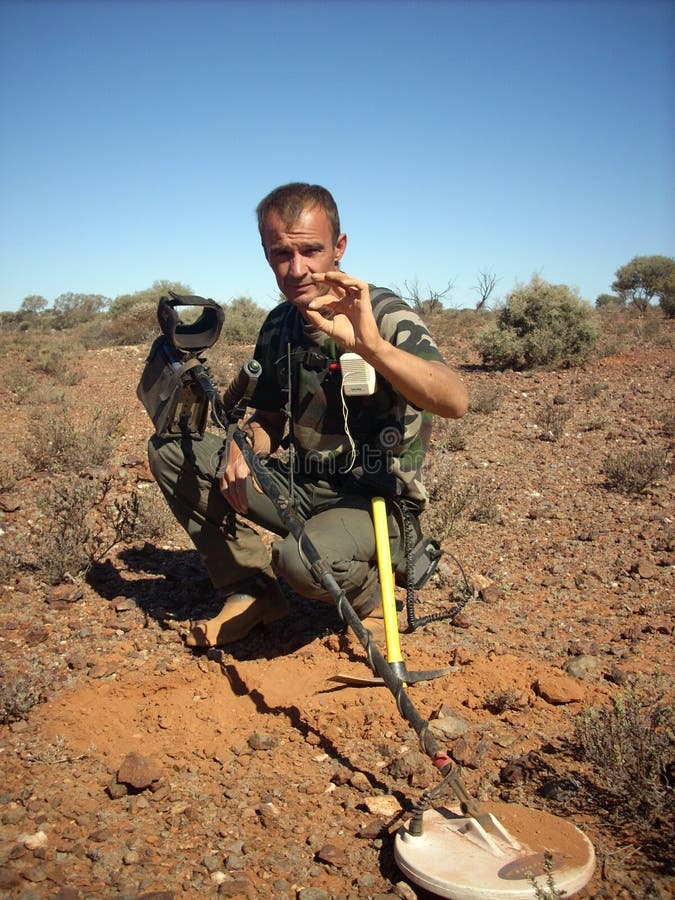 Man finding a small gold nugget stock image