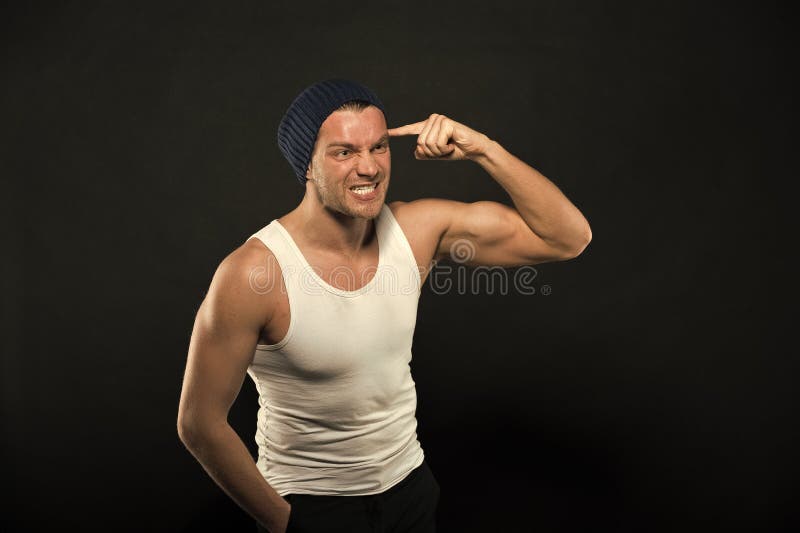 Foto de Athlete athletic build shows the muscles of the chest. Hands  clenched into fists, biceps in tension. Bodybuilder posing on a white  background. do Stock