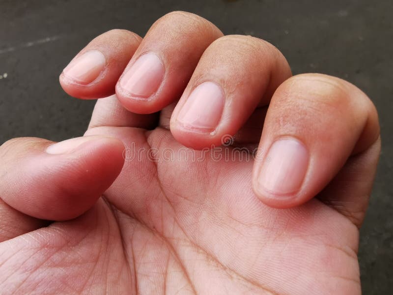 Man fingers with freshly cut nails.