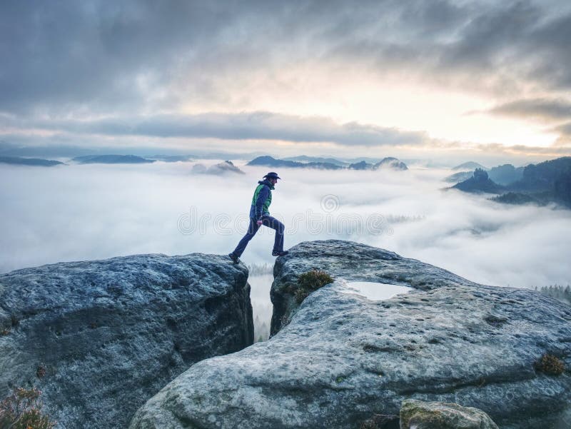 Male hiker finnaly standing on a rock stock and enjoying foggy mountain view, wilderness, walk, sport, solitude, scenics, -, nature, object, river, rear, pondering, person, path, men, one, man, top, nordic, non-urban, scene, climbing, misty, morning, lifestyle, leisure, journey, jacket, holiday, high, handsome, guy, glacier, freedom, female, extreme, terrain, explorer, europe, emotions, copy, space, conquering, adversity, clouds, cliff, challenge, backpacker, authentic, edge, alpinism, alone, adults. Male hiker finnaly standing on a rock stock and enjoying foggy mountain view, wilderness, walk, sport, solitude, scenics, -, nature, object, river, rear, pondering, person, path, men, one, man, top, nordic, non-urban, scene, climbing, misty, morning, lifestyle, leisure, journey, jacket, holiday, high, handsome, guy, glacier, freedom, female, extreme, terrain, explorer, europe, emotions, copy, space, conquering, adversity, clouds, cliff, challenge, backpacker, authentic, edge, alpinism, alone, adults