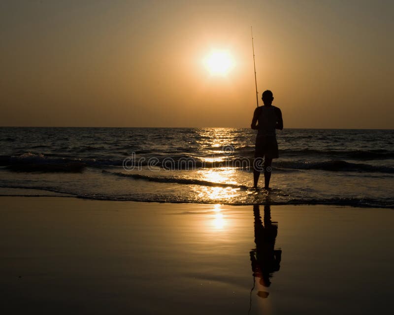 Man fishing at sunset