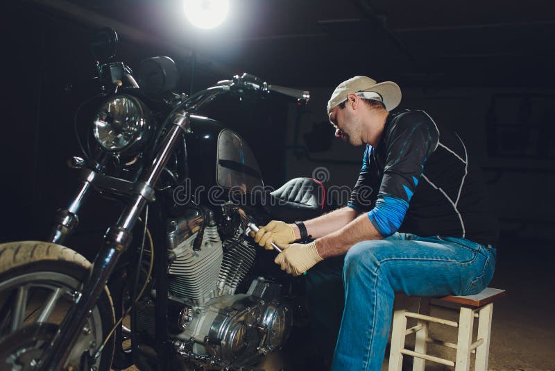 Man Fixing Bike. Confident Young Man Repairing Motorcycle ...