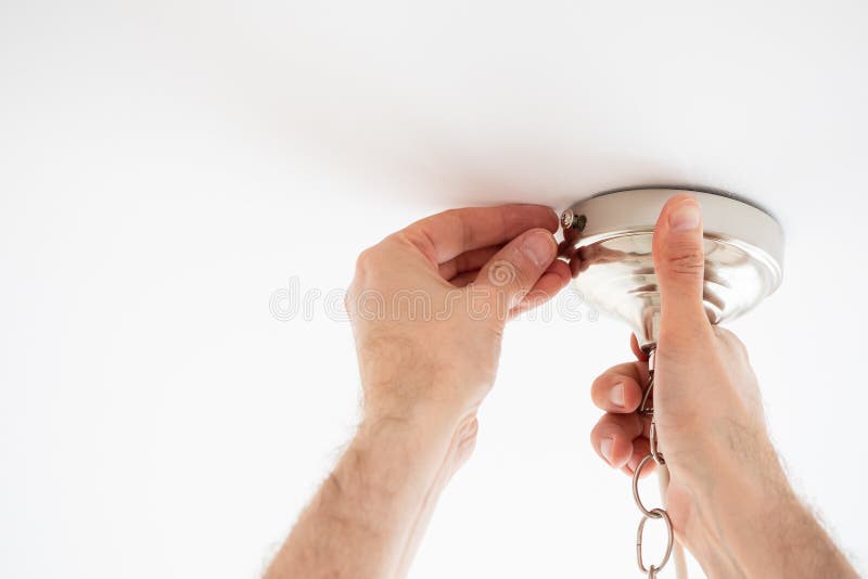Man fixing ceiling light on white background royalty free stock image Man fixing ceiling light on white background royalty free stock image