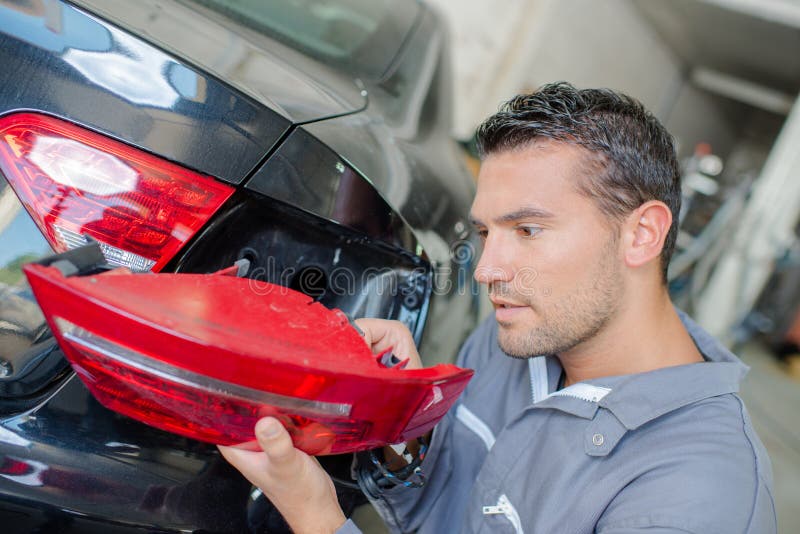 Man fixing tail light car stock image. Image of light 104147815