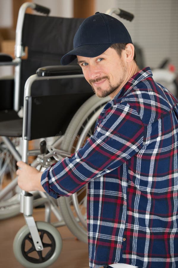 Man fixing wheelchair stock image. Image of wood, wheelchair 271544001