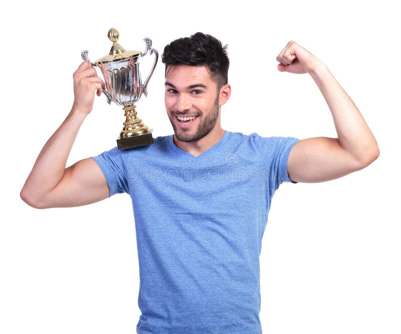 Young man flexing his muscle and holding a trophy cup on shoulder