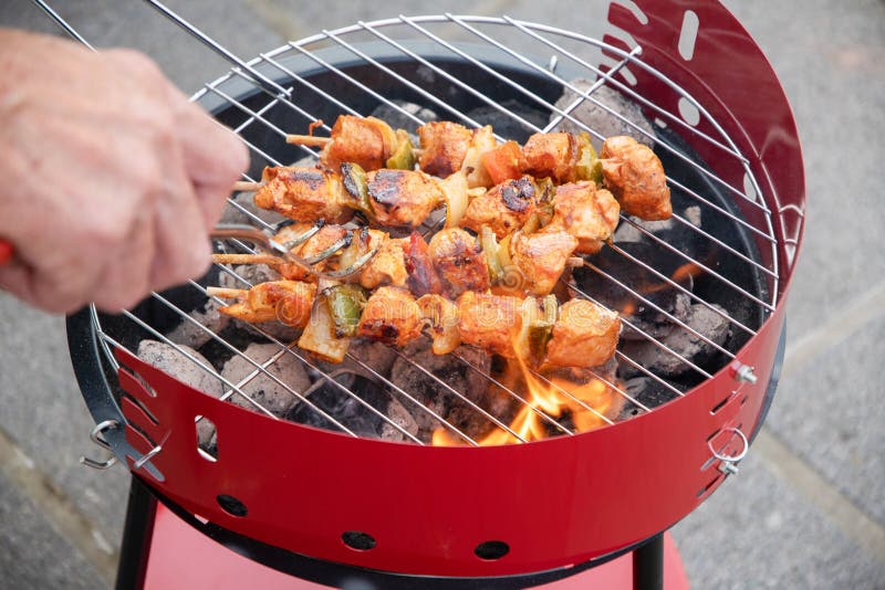 Man Flipping Chicken Skewers on Barbecue Grill Over Hot Coals, Summer ...