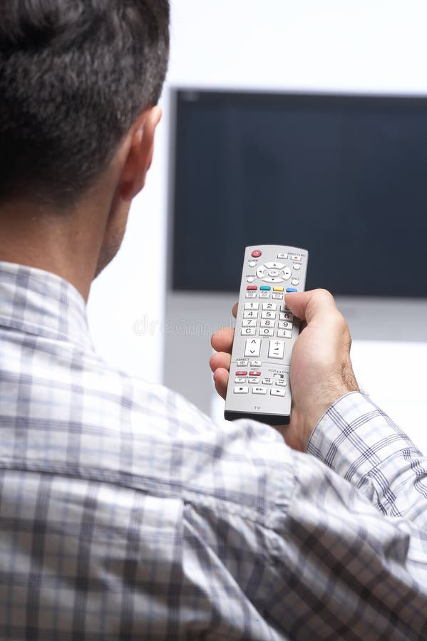 Man in front of tv switching channel