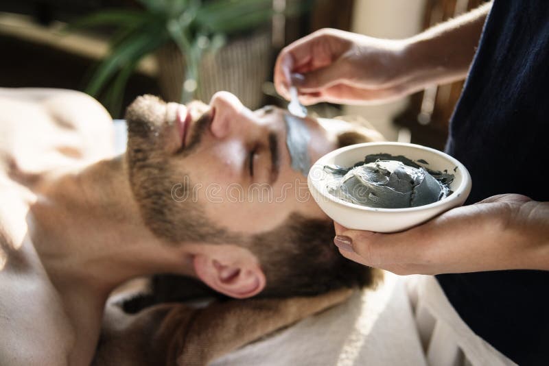 Man getting a mud mask at a spa stock photo