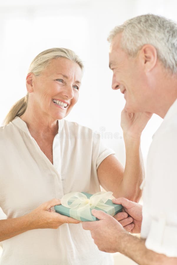 Man Gifting Woman At Home