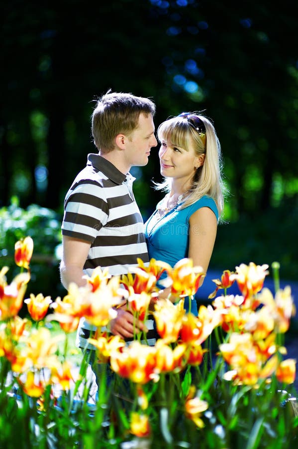 Man and girl among flowers