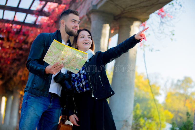 Man and girl help with navigation in the city for a tourist