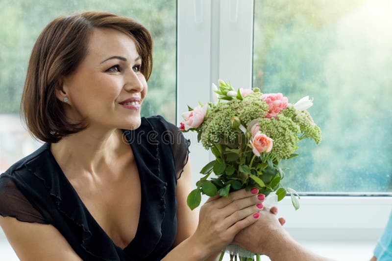 Man giving a bouquet of flowers and surprised woman royalty free stock photos Man giving a bouquet of flowers and surprised woman royalty free stock photos