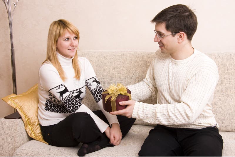 Man is giving gifts woman at Valentines day.