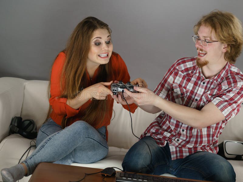 Man gamer teaching his girlfriend playing space shooter video game on RGB  powerful personal computer. Pro cyber woman with headset performing video  games streaming from home during online tournament Stock Photo 