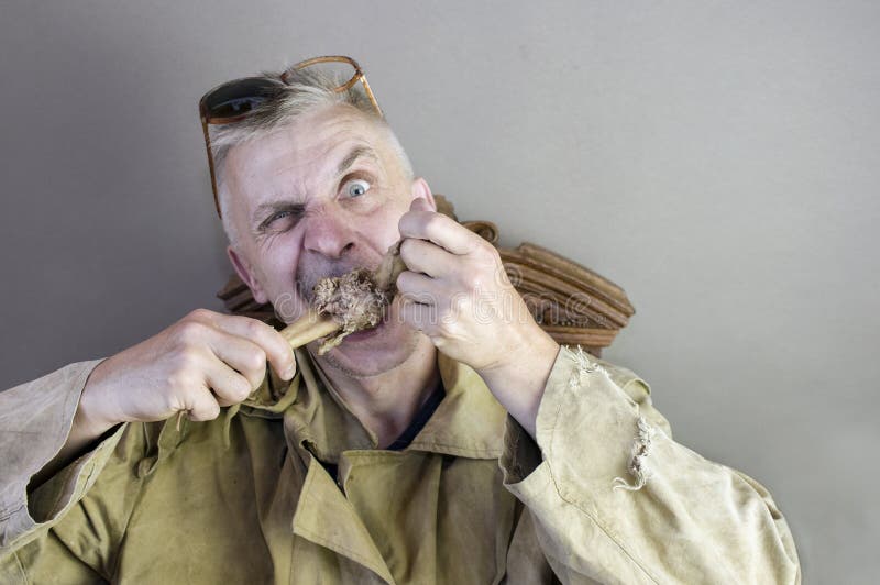 Man Gnawing A Bone royalty free stock photo Man Gnawing A Bone royalty free stock photo