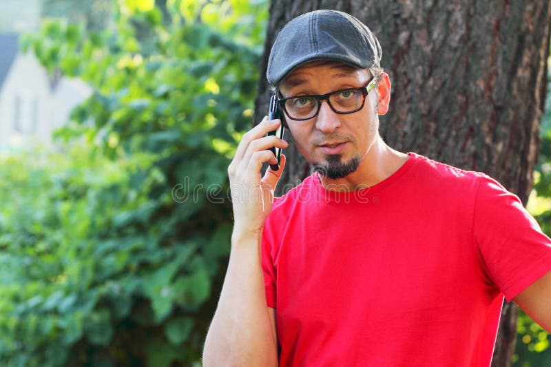 Man with goatee talking on cell phone