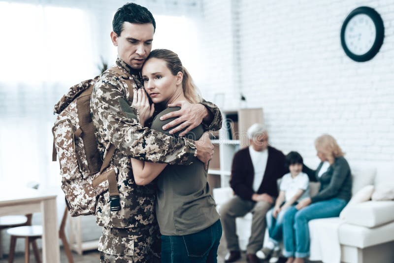 A Man Goes To Military Service. Saying Goodbye. Leaving To Army. Farewell With Family. Camouflage Uniform. Wife Hanging. Feelings Showing. Guard Of Peace. Patriotic Decision. Soldier Emotion. A Man Goes To Military Service. Saying Goodbye. Leaving To Army. Farewell With Family. Camouflage Uniform. Wife Hanging. Feelings Showing. Guard Of Peace. Patriotic Decision. Soldier Emotion.