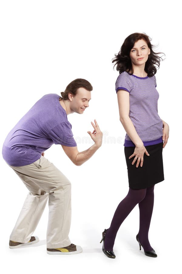 Man going to smack with fingers on back of woman