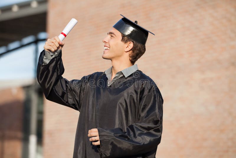 Man in Graduation Gown Holding Diploma on College Stock Image - Image ...