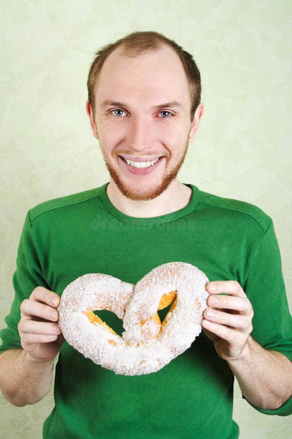 Man in green shirt holding big cracknel