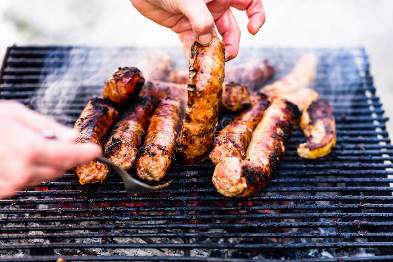 Man Grilling Sausages on a Barbecue Grill Stock Image Image of picnic
