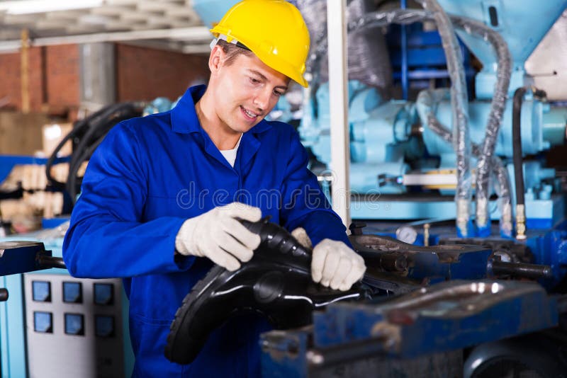 Skilled man working in a gumboot factory. Skilled man working in a gumboot factory