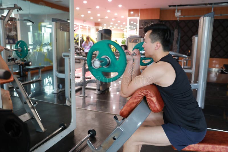 Asian Chinese Man in Gym Lifting Weights Stock Photo Image of clothes
