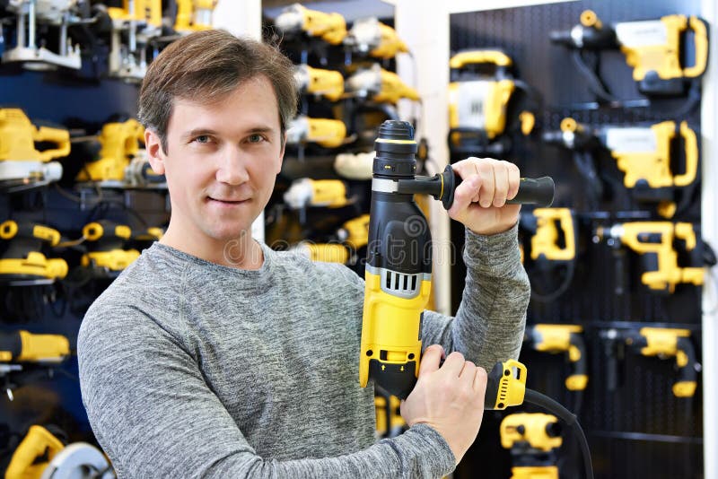 Man with Hammer Drill in Hardware Store Stock Photo Image of customer