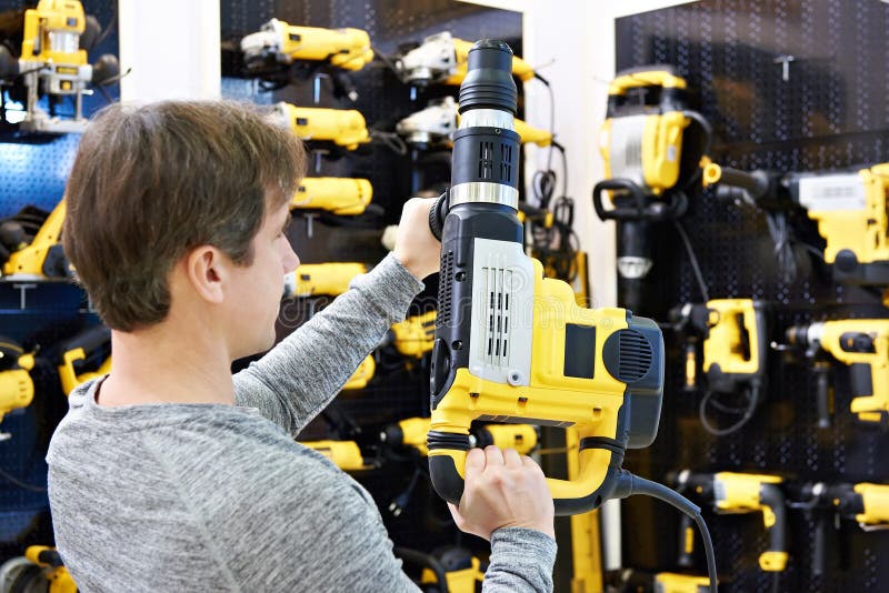 Man with Hammer Drill in Hardware Store Stock Image Image of hardware