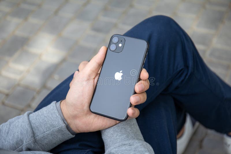 Anapa, Russia - September 26, 2019: Man hand with Apple Watch Series 5 holding iPhone 11. iPhone and Apple Watch was created and developed by the Apple inc